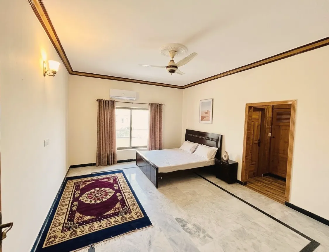 Private single room with a double bed, TV and rug at Health Plus