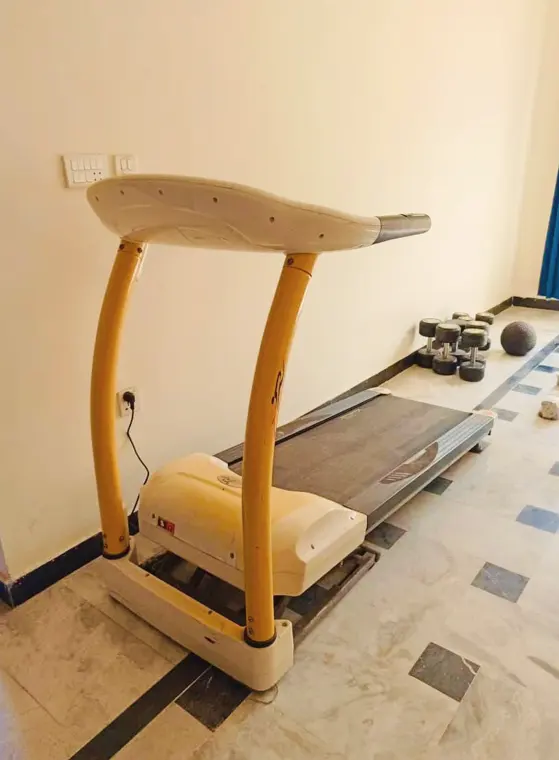 Treadmill and dumbbells in the exercise room